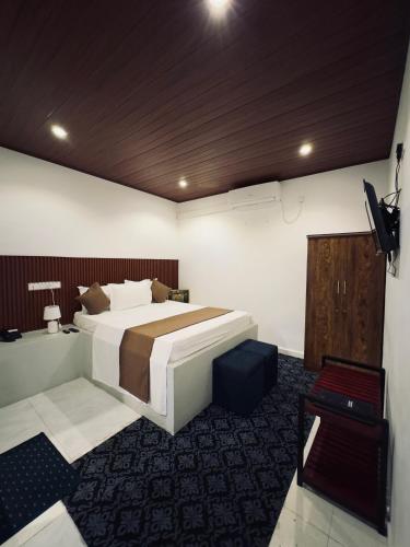 a bedroom with a bed and a television in it at New National in Pettah