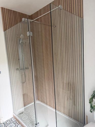 a shower with a glass enclosure in a bathroom at Cosy seaside cottage in Criccieth