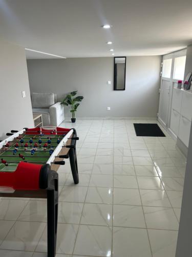 a room with a foosball table in the middle at Chez Lina in Chartres
