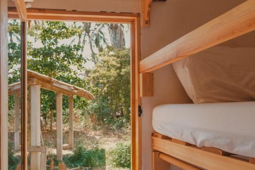 a bedroom with a bunk bed and a window at Casa Antonio Mazunte in Mazunte