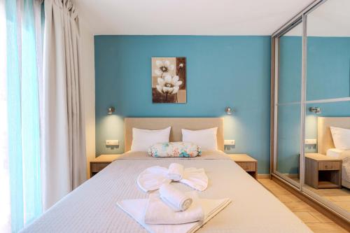 a bedroom with a bed with a pink bow on it at Studios Sotiria in Limenas