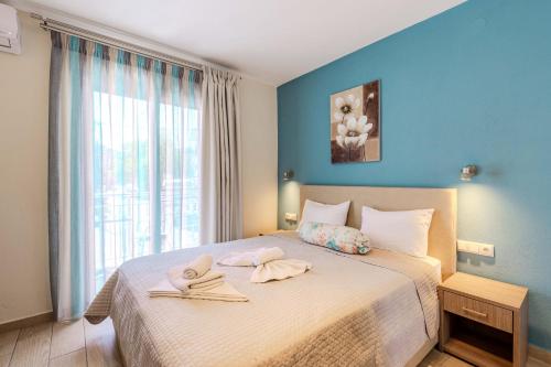 a bedroom with a large bed with towels on it at Studios Sotiria in Limenas