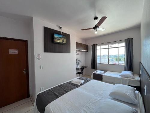 a hotel room with a bed and a window at Rosa's Hotel in Toledo