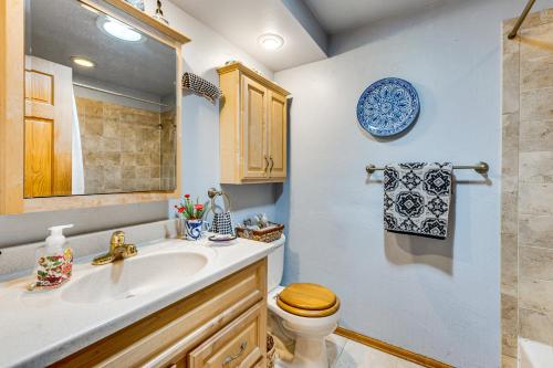 a bathroom with a sink and a toilet and a mirror at Eclectic Multi-Level Charmer! 2 Mi to CU Boulder in Boulder