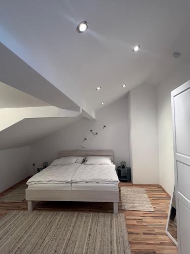 a bedroom with a bed in a attic at Helles, großzügiges Loft mit Fernblick in Siegendorf im Burgenland
