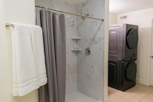 a bathroom with a shower with a glass door at Duchesne River LLC in Duchesne