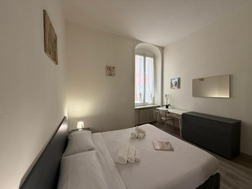 a bedroom with a bed with two slippers on it at LA VIOLETTA DI PARMA // DEL DUCATO in Parma
