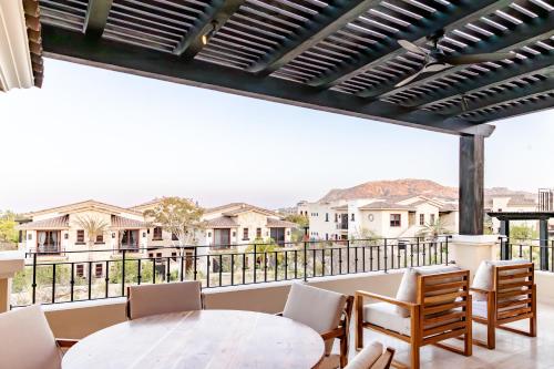 a balcony with a table and chairs and a view at Palmilla Dunes Luxury Residences in San José del Cabo