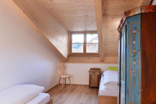 a room with two beds and a window at Residence Simml & Schlosser in San Candido
