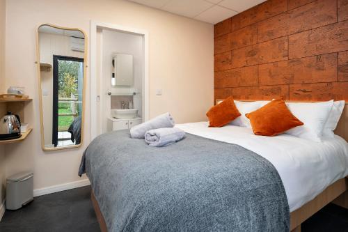 a bedroom with a large bed and a mirror at Nodpod Hotel in Bristol