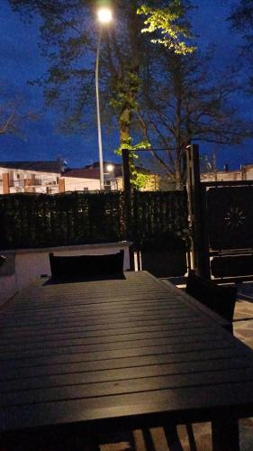 a wooden table with a light on a street at il Biscottino in Castel di Sangro
