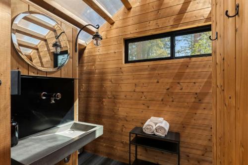 a bathroom with a sink and a mirror at Under Canvas Yosemite in Groveland