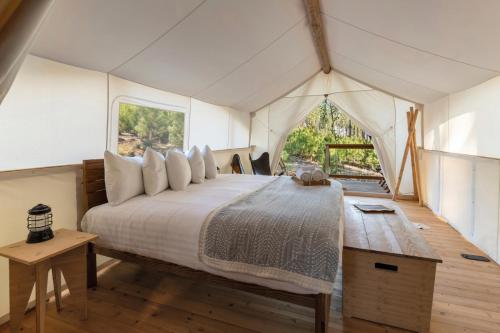 a bedroom with a bed in a tent at Under Canvas Yosemite in Groveland