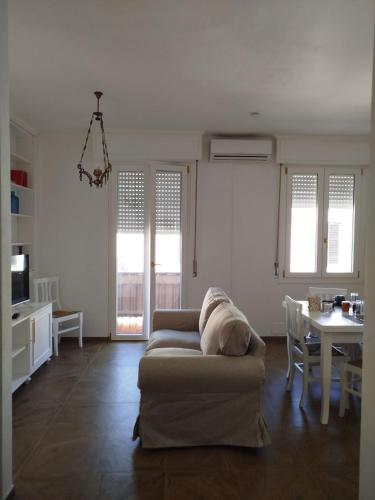 a living room with a couch and a table at Turquoise Horizon in Stintino