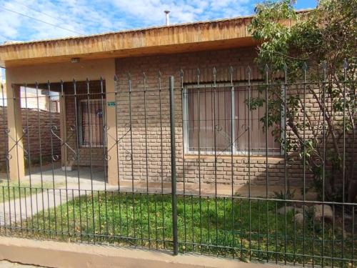 a house with a fence in front of it at Alquiler por Día SyA Cipolletti in Cipolletti