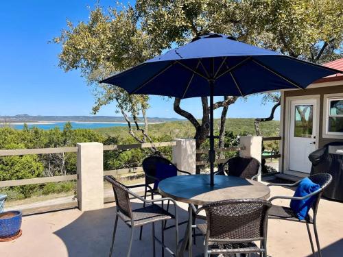 a patio with a table and chairs and an umbrella at Canyon Lake House with Lake View in Canyon Lake