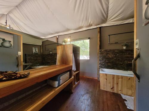 a room with a tub in a tent at Rustic Gate Lodge and Campsite in Maun