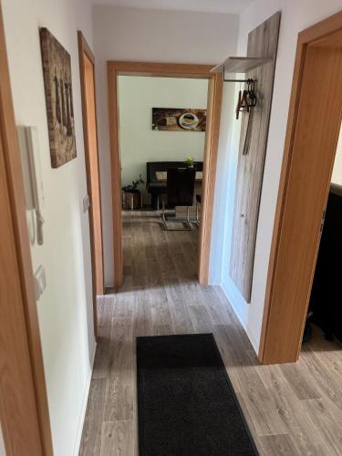 a hallway with a door leading to a living room at Fewo Am Poetenteich in Jänkendorf
