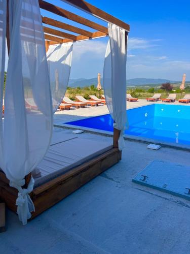 a view of a swimming pool from a resort with a canopy at Narnia Cottages in Bazalet'i