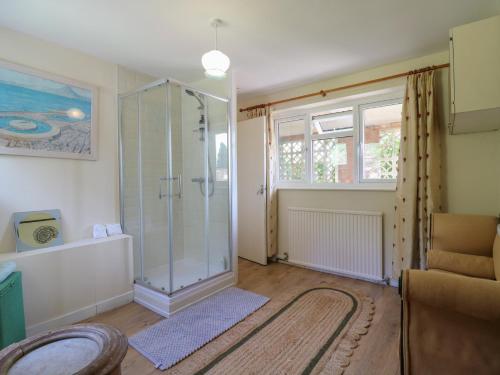 a bathroom with a shower and a glass shower stall at The Lodge in Colchester