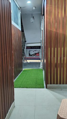a hallway with a green carpet in a building at HOTEL BPR Residency in Hyderabad