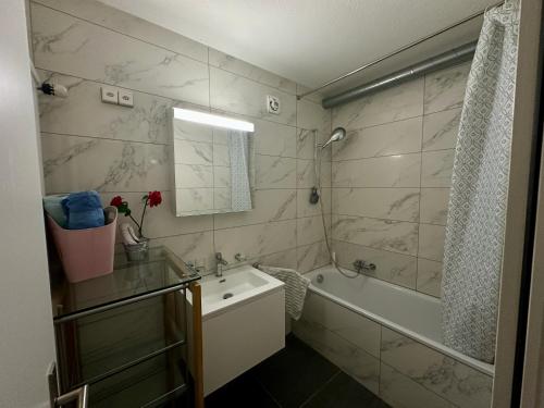 a bathroom with a tub and a sink and a shower at Royal Apartment 02 in Schaan