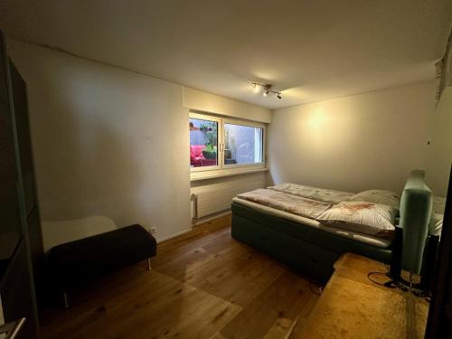 a small bedroom with a bed and a window at Royal Apartment 02 in Schaan