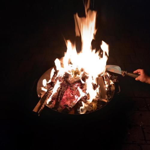 a person holding a spatula in front of a fire at Timmy Hope in Vienna