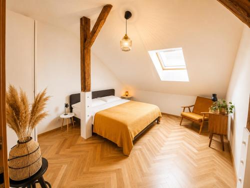 a bedroom with a bed in a room at Podkrovní Apartmán in Třebíč