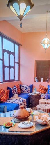 a room with couches and a table with plates on it at Atlas Rooftop Imlil in Imlil