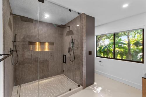 a bathroom with a shower with a glass door at Platinum Villa w Karaoke, Pickleball, BKB & Soccer in Davie