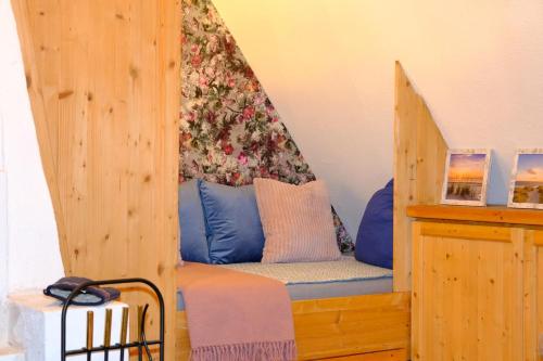 a bed in a wooden room with a canopy at Judies Garten in Füsing