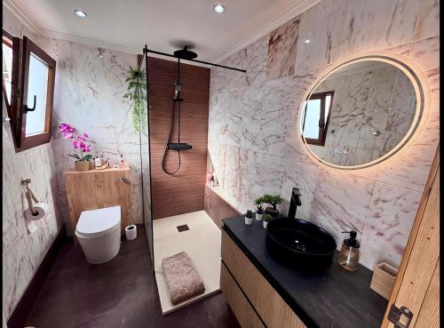 a bathroom with a black sink and a mirror at Montevistas Retreat- Cycling, Hiking, Relaxation, Valencia 25 minutes in Valencia