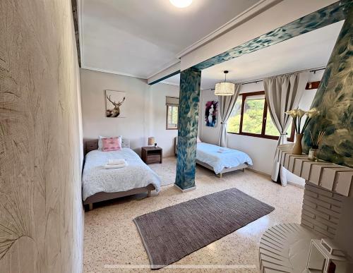 a bedroom with two beds and a window at Montevistas Retreat- Cycling, Hiking, Relaxation, Valencia 25 minutes in Valencia