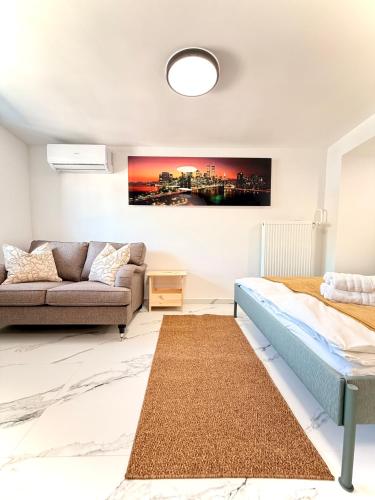 a bedroom with a bed and a couch at The LOFT Apartments Ljubljana in Ljubljana