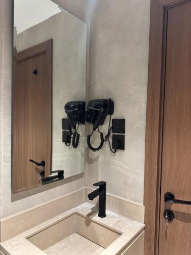 a bathroom with a sink and a mirror at سويت مسك غرفة وصالة بلمسة عصرية راقية in Dammam