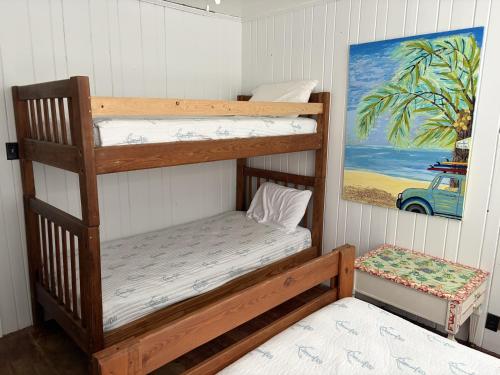 a room with two bunk beds and a painting at The Dunes in St. Augustine