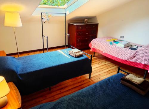 a room with two beds and a dresser in it at Sunrise in Rapallo