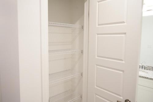 a white closet with a white door at Charming Oakville Getaway in Oakville