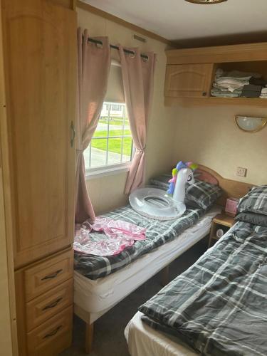 a small room with a bed and a table in a bedroom at Nickys happy place in Greencastle