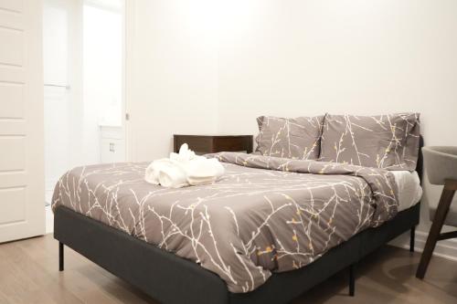 a bed with a white towel on top of it at Charming Oakville Getaway in Oakville