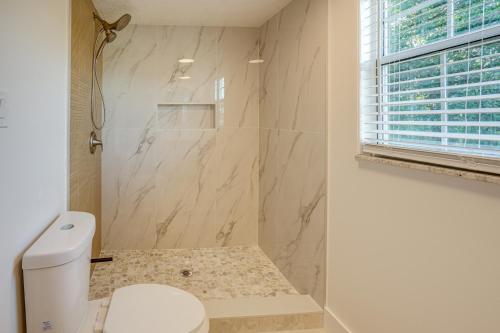 a bathroom with a shower and a toilet in it at Deck + Pool Table! Walk to Dtwn Jensen Beach in Jensen Beach