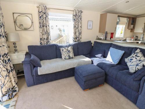 a blue living room with a blue couch at Plot 42 in Carlisle
