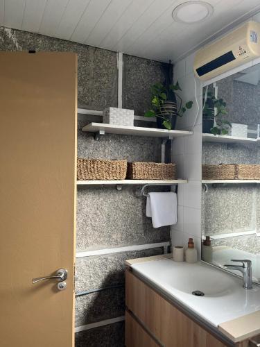 a bathroom with a sink and a counter top at Casa Xoubiña in Mos