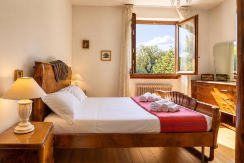 a bedroom with a bed with two towels on it at Villa Le Rose, Menaggio in Menaggio