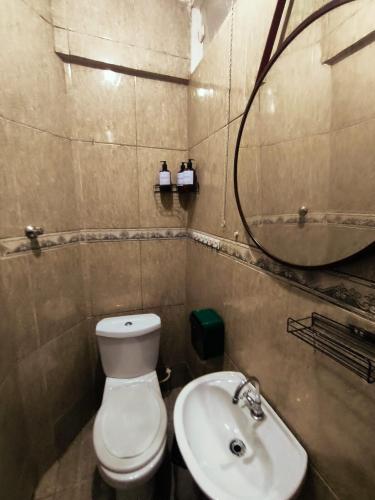 a bathroom with a toilet and a sink and a mirror at Studio Premium - ap 05 in Diadema