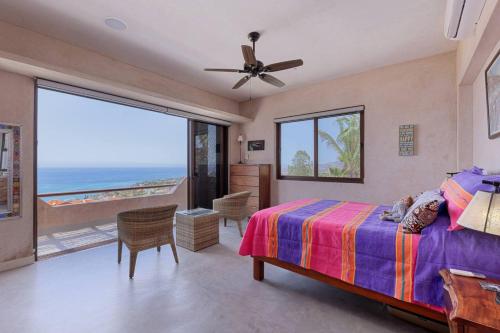 a bedroom with a bed and a view of the ocean at 2BR with Stunning Ocean Views in Las Palmas