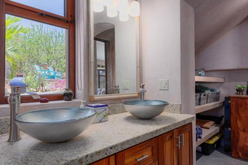 a bathroom with two bowl sinks on a counter at 2BR with Stunning Ocean Views in Las Palmas