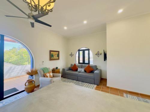 a living room with a couch and a window at Near Beach Casita With Firepit in Los Barriles
