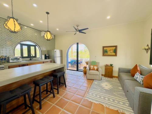 a kitchen and living room with a counter and a couch at Near Beach Casita With Firepit in Los Barriles